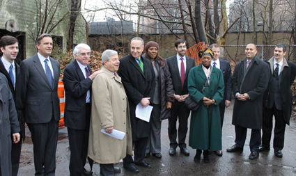 Among those pictured at Fridayâ€™s press conference at the Brooklyn Navy Yard are Brooklyn Borough President Marty Markowitz (in tan raincoat), U.S. Senator Charles Schumer (holding paper), Andrew Kimball of the BNYDC (third from right), with other elected officials.  Photo courtesy of Sen. Charles Schumer