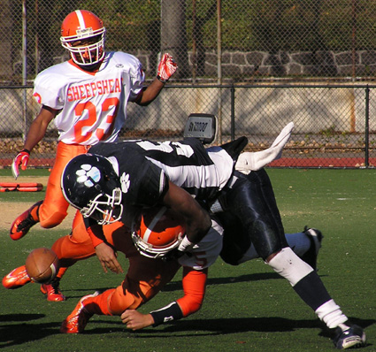 Toba Akinleye forces a fumble on his tackle during this seasonâ€™s game against Sheepshead Bay.  Playing defensive end, Akinleye had 17 sacks on the season and was named to the PSAL All-City team. Eagle photos by Jim Dolan