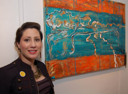 Artist Natalie Katz poses near her mixed media piece.