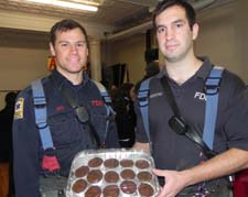 Firefighters Bill Long, left, and Frank Sciortino are happy with the cupcakes they were given.