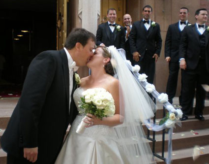 John Quaglione kisses his bride Kerry outside St. Anselm Church on their wedding day.