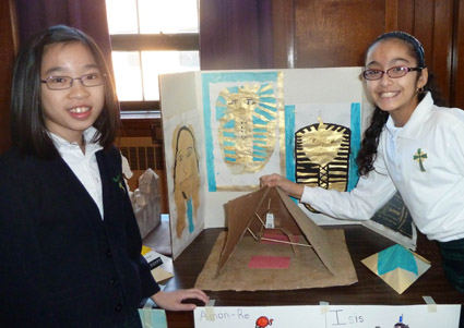 Sixth-graders Jessica Hui (left) and Tiana Eladem give a photographer a peek inside their detailed Egyptian pyramid. 	Eagle photo by Rick Buttacavoli