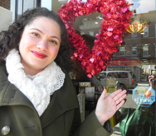 Tatiana Nicoli, co-president of the 13th Avenue Merchants Association, points to a â€œSafe Stopâ€ decal in the window of her shop, Boulevard Books & CafÃ©, at 7518 13th Ave.