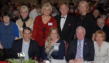 Seated (left to right) are contest judge Steve Danna of Den Norske Bank; Event Co-Chair Lynn Anderson, state Sen. Marty Golden and contest judge Lena Barnes. Standing (left to right) are Dee Rutuelo, contest judge Ingebord Vidringstad, Event Co-Chair Arlene Rutuelo, Master of Ceremonies Rolf Kristian Stang, and contest judge Joyce Abrahamsen. 	Eagle photos by Georgine Benvenuto     