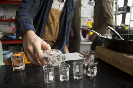 Peter Simon pours samples of their most recent run of vodka. Photo by Zach Campbell