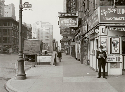 In this May 18, 1940, photo provided by the New York City Municipal Archives, a man reads a newspaper on New Yorkâ€™s Sixth Avenue at 40th Street, with the headline â€œNazi Army Now 75 Miles From Paris.â€ 