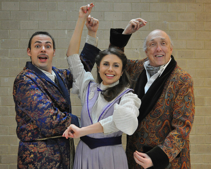 Cast members John Hailey as Henry Higgins, Ashley Harris as Eliza Doolittle, and Cliff Hesse as Colonel Pickering in a performance of â€˜By George, I think sheâ€™s got it!â€™ in Narrows Community Theaterâ€™s production of â€˜My Fair Lady.â€™