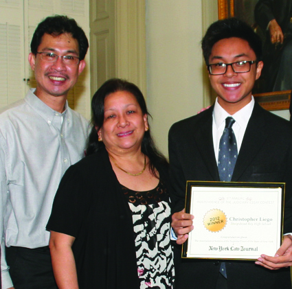 Essay contest grand prize-winner Christopher Liego, of Sheepshead Bay High School, with his family and his award. Liego will have his essay published in an upcoming edition of the New York Law Journal.