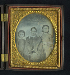 This image provided by the Museum of the Confederacy shows a Daguerreotype, of a women and two children found in the effects of a soldier identified as Joseph Warren during the Civil War. AP photo