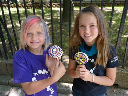 Rebecca Back (left) and India Leier, third-graders, show off their edible creations decorated at the Food Art for Kids table.