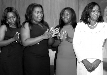 Hon. Hinds-Radixâ€™s three daughters applaud her as she is sworn in as BWBA President.