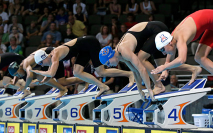 Brooklyn's Lia Neal (at left) dives with (from right) Margo Geer, Amanda Weir and Madison Kennedy at the start of a heat in the women's 50-meter freestyle preliminaries at the U.S. Olympic swimming trials on Saturday. AP Photo/Mark Humphrey