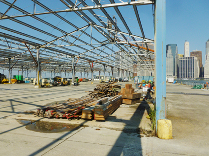 Pier 2, with its shed framework still intact, will hold five basketball courts, adult exercise equipment, and courts for other games, partly under translucent roofing. Work is now underway to shore up the pier. Regina Myer, president of the park, is eager to have this pier completed before Mayor Bloomberg leaves office at the end of next year. Photo by Henrik Krogius