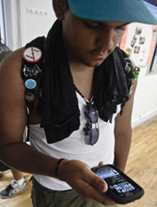 Justin Rosado, 17, views "Stop andFrisk Watch," a phone app for monitoring police action. AP photo by Bebeto Matthews 