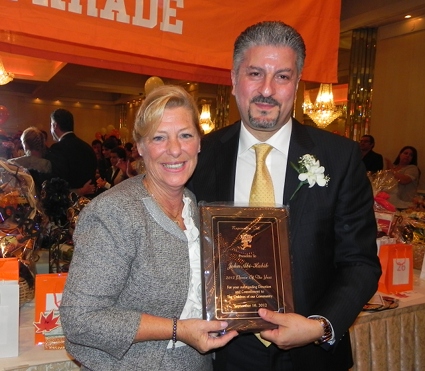John Abi-Habib, the Ragamuffin man of the year, receives his plaque from Colleen Golden, president of Ragamuffin Inc., the parade sponsor.
