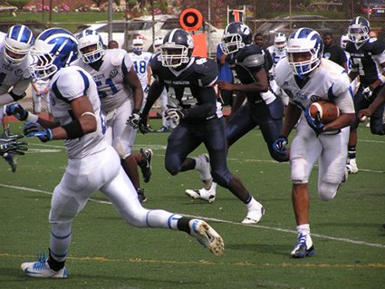 The Tigersâ€™ Khalif Tolluch (#44) is closet defender to Brooklyn Techâ€™s James Gales as he follows his blockers downfield for a 44-yard touchdown, his third of the game. 