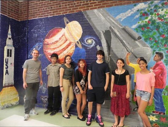 Guidance counselor Yaron Dotan (left) encouraged and the student artists who created this mural, with an exploration theme