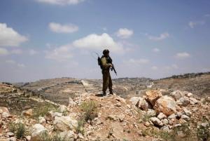 An Israeli soldier patrols the landscape