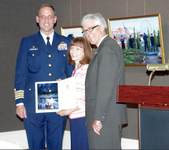 Karen Loew receives Public Service Award certificate from USCG Captain Gordon Loebl at left, and Salmagundi president Robert Pillsbury at right