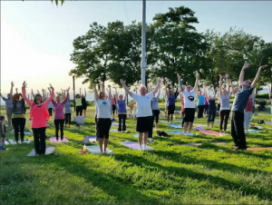 State Sen. Marty Golden and Assemblywoman Nicole Malliotakis (front row, center) not only sponsored the free yoga class in Shore Road Park on Tuesday, they took part in it.png