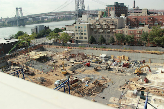 Bird's eye view of concrete being poured at the Oosten site, and what a view, what with the Williamsburg Bridge and all. Photo by Shawn A. Lawrence