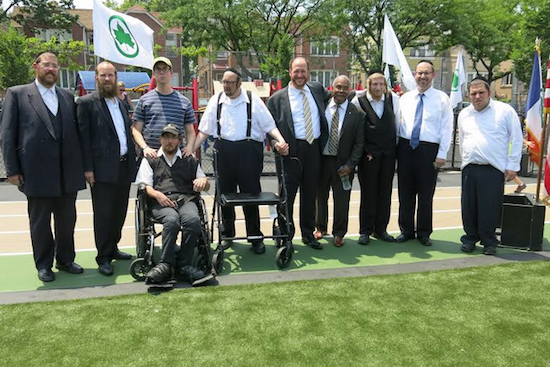 Councilman David Greenfield, Brooklyn Parks Commissioner Kevin Jeffrey, state Sen. Simcha Felder and local residents celebrate the grand opening of a new park on 18th Avenue and 48th Street. The playground boasts the first wheelchair accessible slide in Brooklyn, according to Greenfield