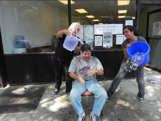 Councilman Vincent Gentile gets doused not by one, but by two buckets of ice water, courtesy of Bay Ridge businesswoman Arlene Rutuelo (left) and Assemblywoman Nicole Malliotakis outside his district office on Fifth Avenue Wednesday morning. Eagle photo by Paula Katinas