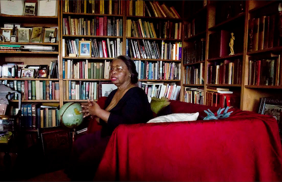 Jean Green Dorsey is seated on her sofa among shelves of books at her rent-stabilized apartment in Manhattan’s Upper West Side. Dorsey, who lived in the apartment since 1972, is among a growing group of New Yorkers who live in the same building with market rate residents. AP Photo/Bebeto Matthews