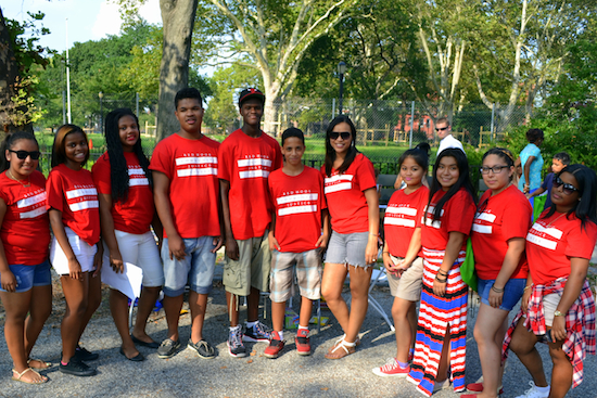 Sabrina Carter (center in glasses), the youth community programs coordinator, with kids from the Red Hook Youth Court during the 76th Precinct’s Night Out in Coffey Park. Photo by Rob Abruzzese.