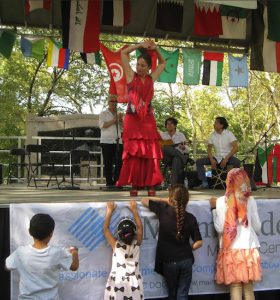 When several children gravitate to the grandstand at the Arab-American Heritage Festival, Tiana responds to them with a special dance. Photo by Francesca Norsen Tate