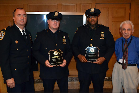 The 84th Precinct’s new captain Sergio Centa (left) and the precinct’s community council president Leslie Lewis (right) honored police officers Thomas Murray and Leonard Clarke as the Cops of the Month for September during captain Centa’s first community council meeting as captain of the 84.