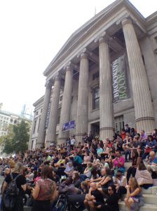 The steps of Brooklyn Borough Hall served as seats for an audience listening to a panel of authors.