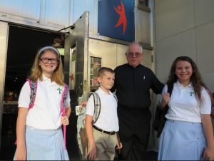 The Rev. Msgr. Michael Hardiman, pastor of Saint Patrick Catholic Church, welcomes students back on the first day of school on Wednesday.