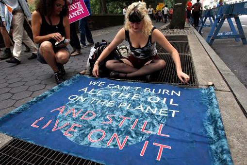 A demonstrator prepares a sign prior to Sunday's Climate March in New York City.