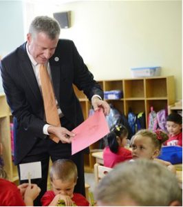 Bill de Blasio, seen here on the first day of school, is encouraging more New Yorkers to get a municipal ID cards.