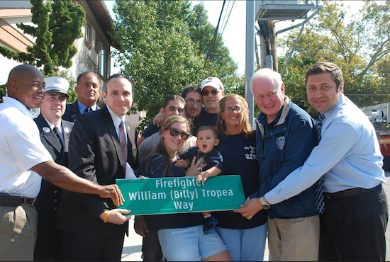 Members of the Tropea family and firefighters unveil the new street sign with help from Borough President Eric Adams (left), Councilmember Mark Treyger (fourth from left) and state Sen. Marty Golden (second from right).