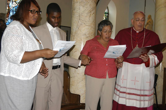 Bishop DiMarzio and interfaith community leaders join in chorus of “We Shall Overcome.” Second from left: Jashaan Brown, who read a prayer on behalf of all the African American youth. Photo Credits: Marie Elena Giossi/The Tablet.