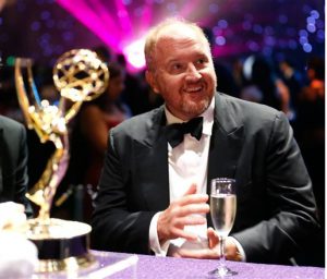 Comedian Louis C.K. sits with his prize at last month's Emmy Awards.