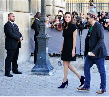 French actress Marion Cotillard, center, arrives at Dior's Spring/Summer 2015 ready-to-wear fashion collection presented in Paris on Friday. It's her birthday today.