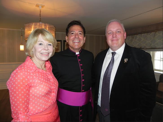The Rev. Msgr. Jamie Gigantiello, (center) the grand marshal of this year’s Ragamuffin Parade, is greeted by Ragamuffin Parade Committee member Barbara Slattery and Committee Treasurer Dave Ryan as he arrives at the Bay Ridge Manor.