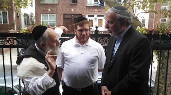 Assemblymember Dov Hikind (right) hears from Borough Park constituents about their difficulties receiving mail.