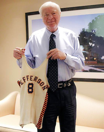 Alan B. Miller holds his Jefferson High School Jersey from the undefeated 1954 basketball team.