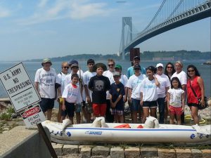 Thomas Greene (far left) led students on a cleanup of Denyse Wharf in July. He is fighting an uphill battle to get the city to build a marine science lab at the location. Photo courtesy Friends of Denyse Wharf