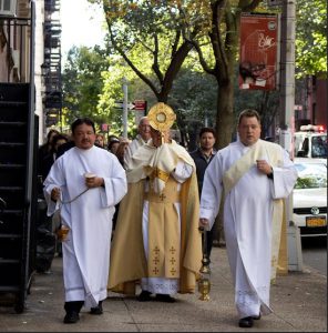 Monsignor James Root of Our Lady of Lebanon carries the monstrance housing the Blessed Sacrament while Fr. Joseph Hugo and Deacon Norbert carry the thuribles with the incense. Eagle photo by Francesca Norsen Tate