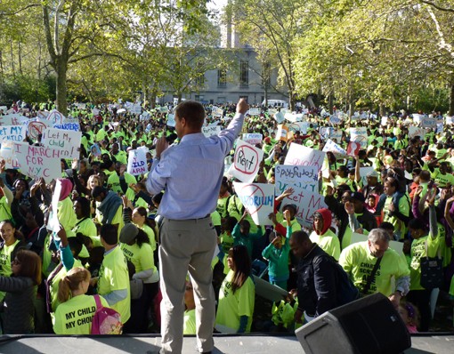 Success Academy administrator Jim Manly rallies families attending a charter school march in Brooklyn last October. Photo by Mary Frost