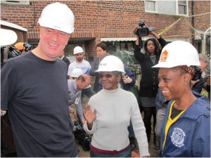 Mayor Bill de Blasio (left) joined his wife, Chirlane McCray (right), to work with Habitat for Humanity at a storm-damaged home in Coney Island, where 80-year-old Margurie Batts (center) has lived for 37 years. Photo by Matthew Taub