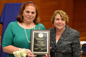Hon. Ellen Spodek (right) presents Lucinda “Lucy” DiSalvo with her Employee of the Year award on behalf of the New York State Supreme Court, Second Judicial District.