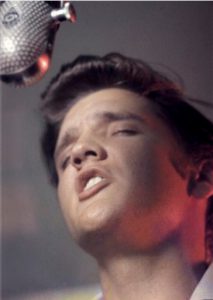 This 1956 photo provided by courtesy of Taschen shows Elvis Presley singing "Don’t Be Cruel," at RCA Victor Studio 1, in New York, on the cover of the book, "Elvis and the Birth of Rock and Roll," by Alfred Wertheimer. Wertheimer died at 85.