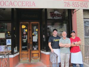 Francesco ‘Frank’ Buffa and his two sons stand outside Ferdinando’s Focacceria at Union and Hicks streets.