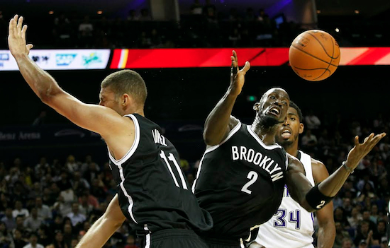Kevin Garnett and Brook Lopez look to corral a rebound during the Nets’ exhibition win in Shanghai Sunday.